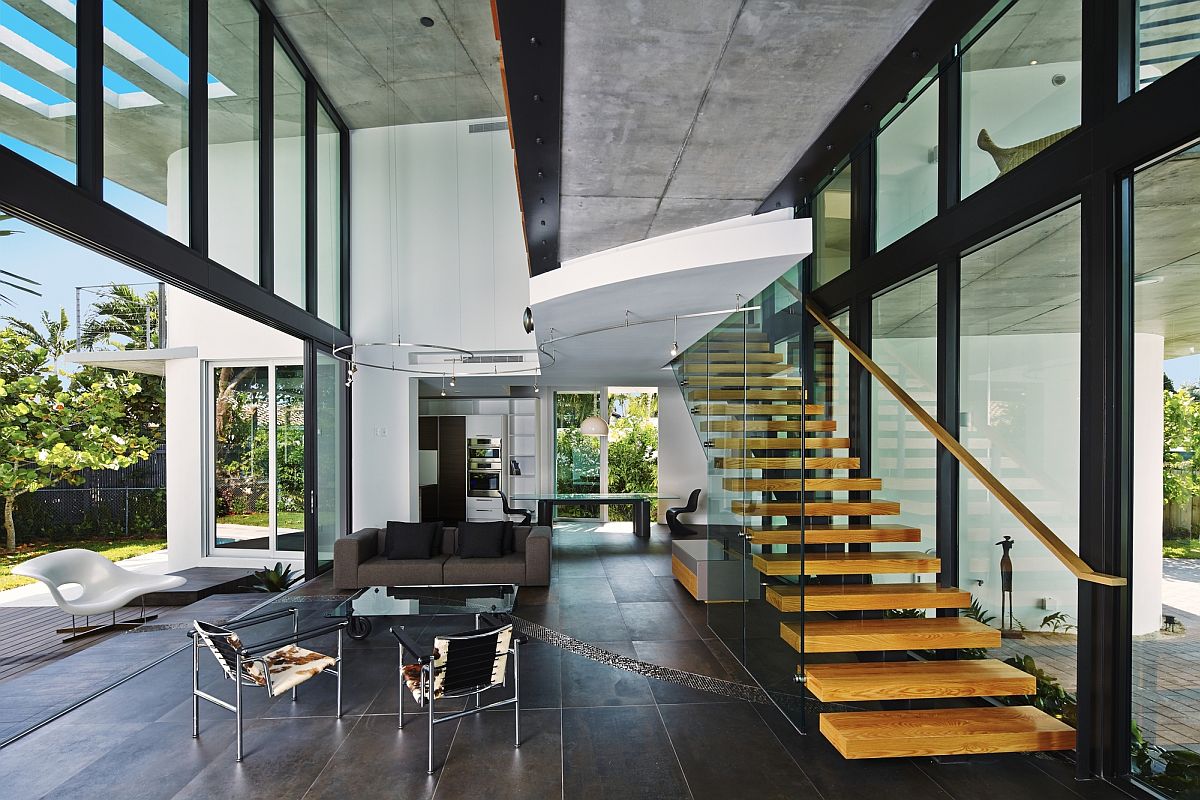 Exquisite living area with glass walls and floating staircase