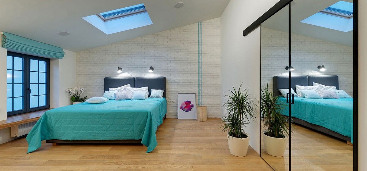 Gorgeous bedroom in white and blue with a brick accent wall