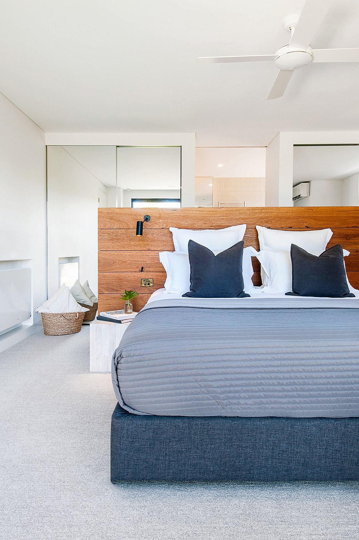 Headboard acts as a visual partition in this relaxing bedroom