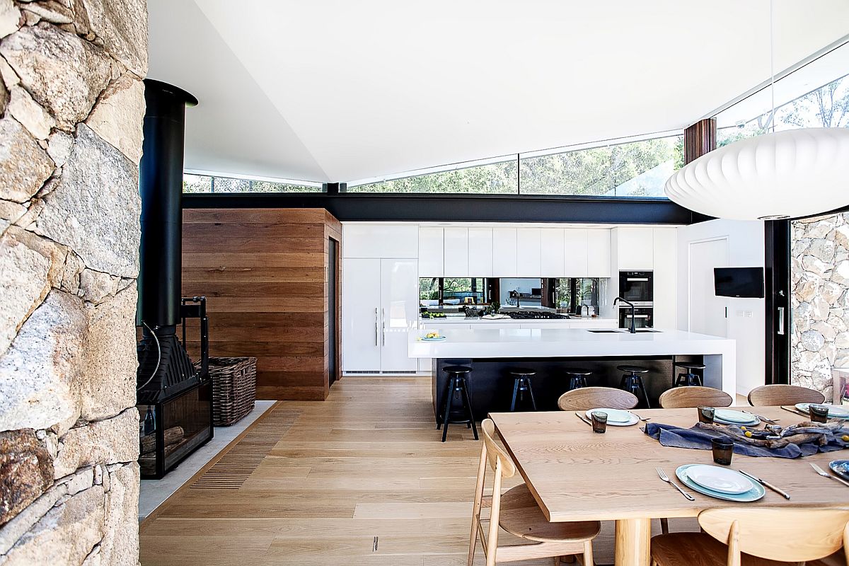 Kitchen cabinets in white add contrast to the smart interior