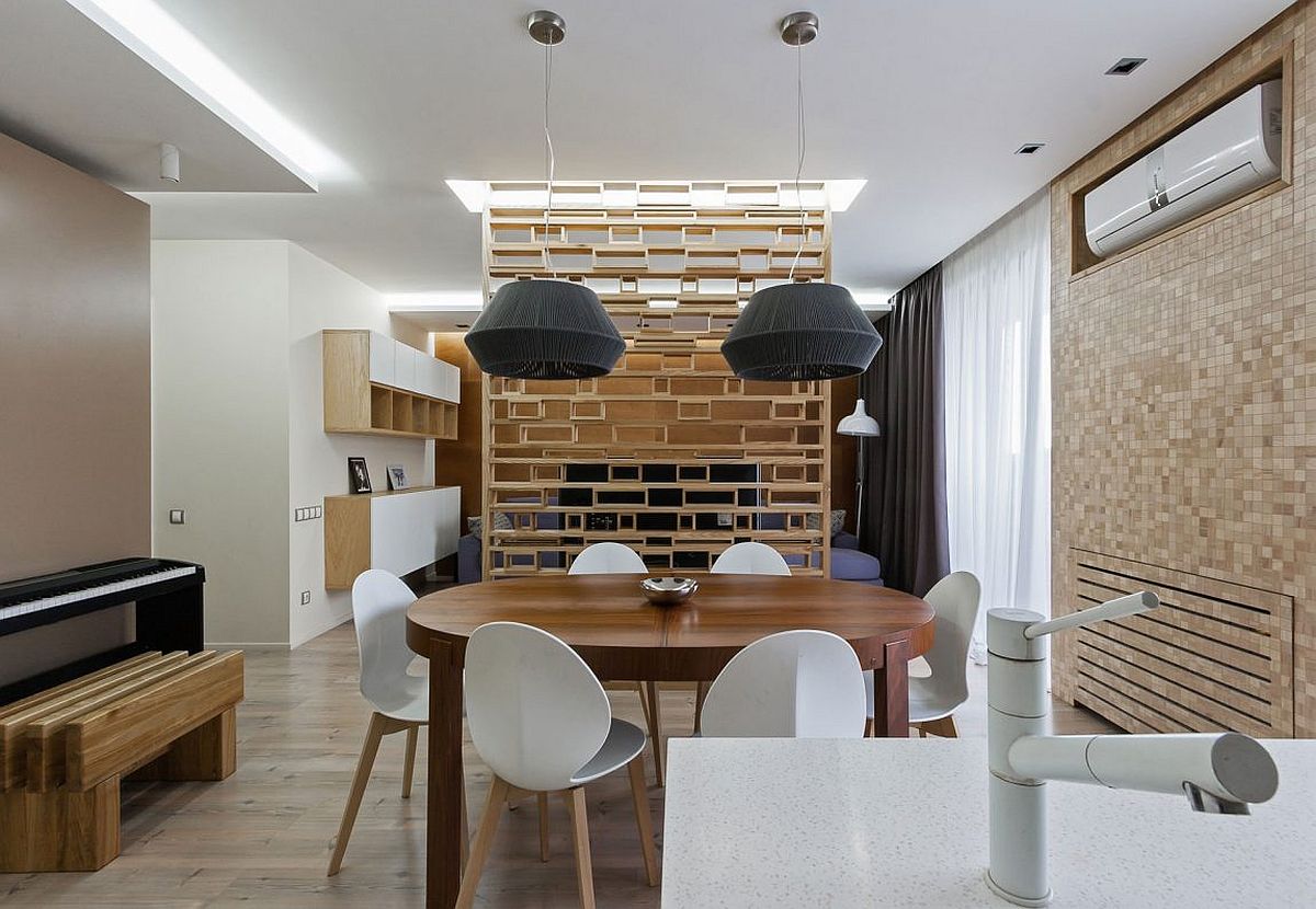 Large pendant lights complement the style and form of the dining table