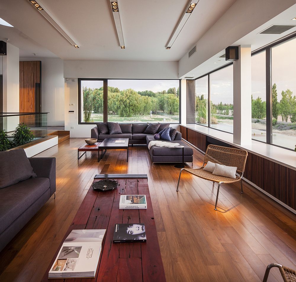 Large windows in the living room offer a view of the river outside