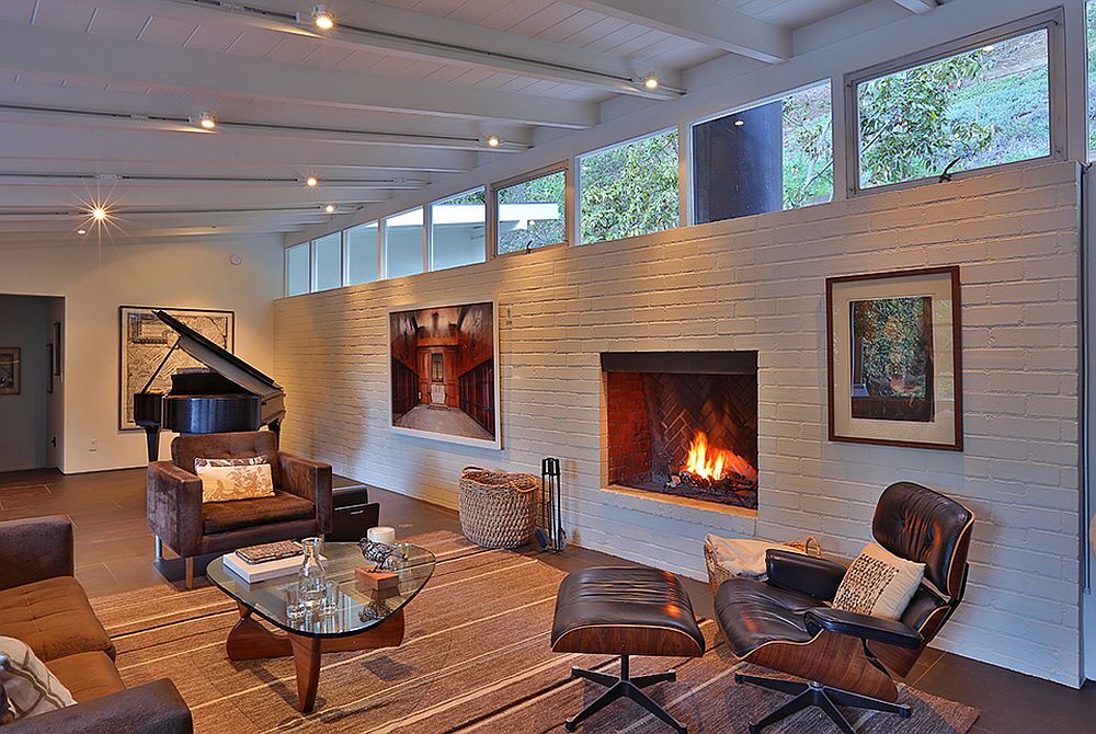 Living room brick wall painted white with a fireplace
