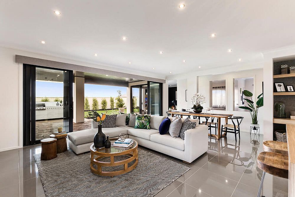 Living room with lovely ambient lighting, sparkling floor and a sectional in white