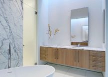 Marble-countertops-and-background-add-an-air-of-luxury-to-the-contemporary-bathrooom-217x155