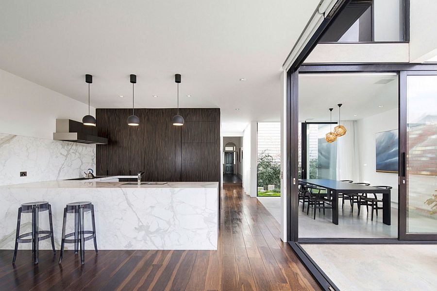 Marble kitchen island and backsplash give the interior a vibe of luxury