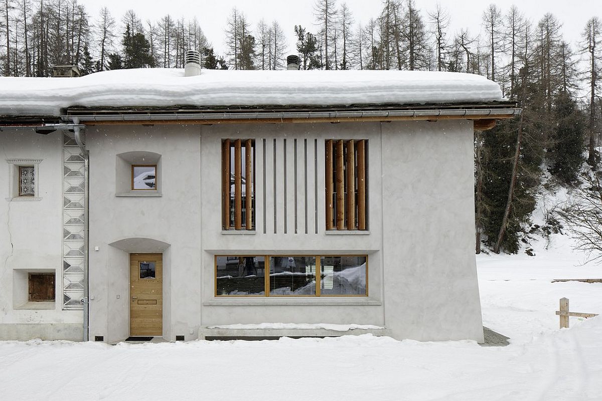 Plastered exterior walls and smart windows transform the old structure into a beautiful home