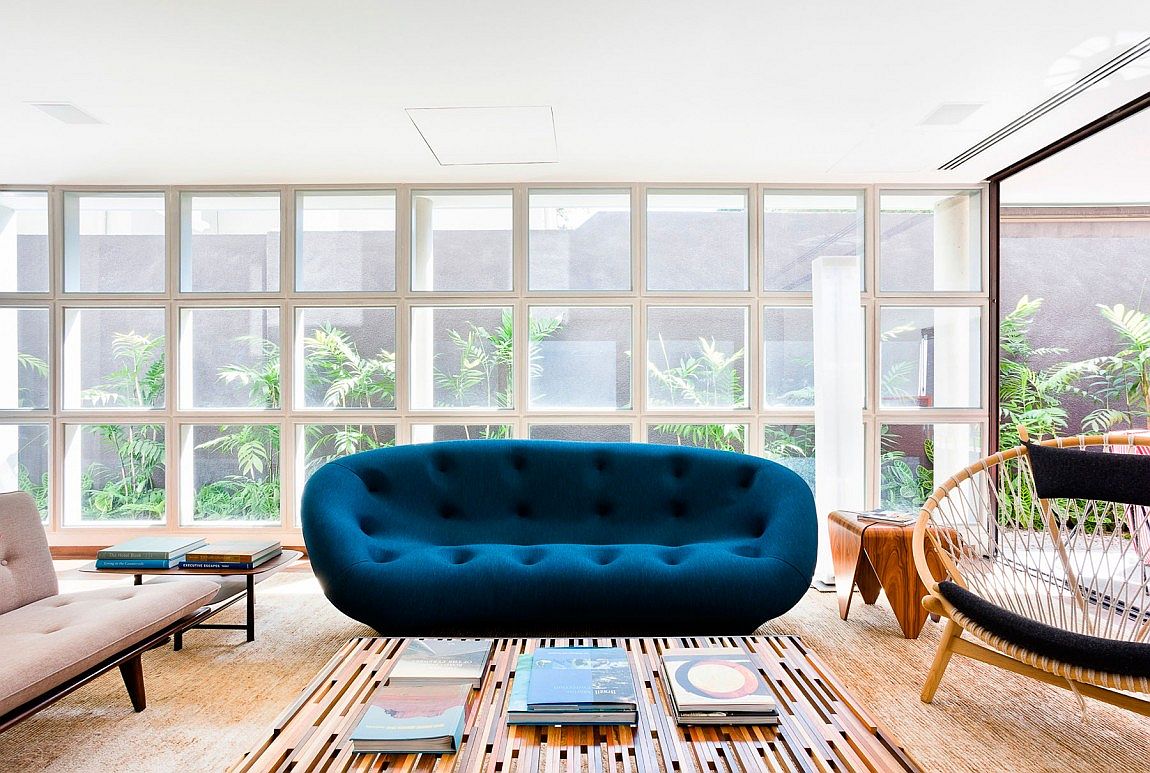 Plush and colorful couch in navy blue for the vivacious living space of AA House