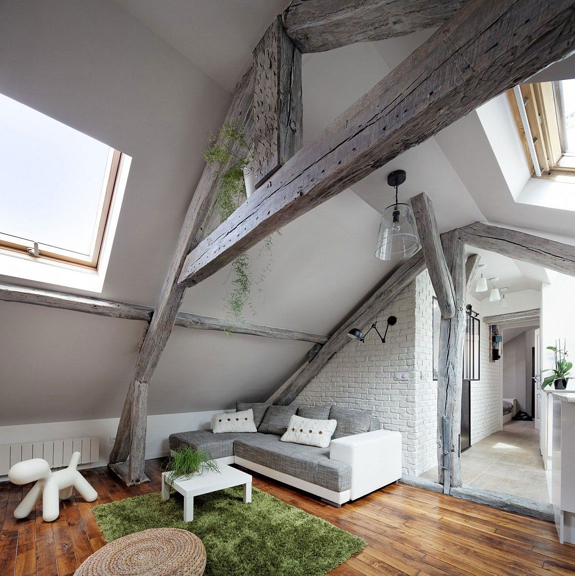 Polished concrete, wood, brick and other contrasting finishes inside the fabulous Parisian apartment