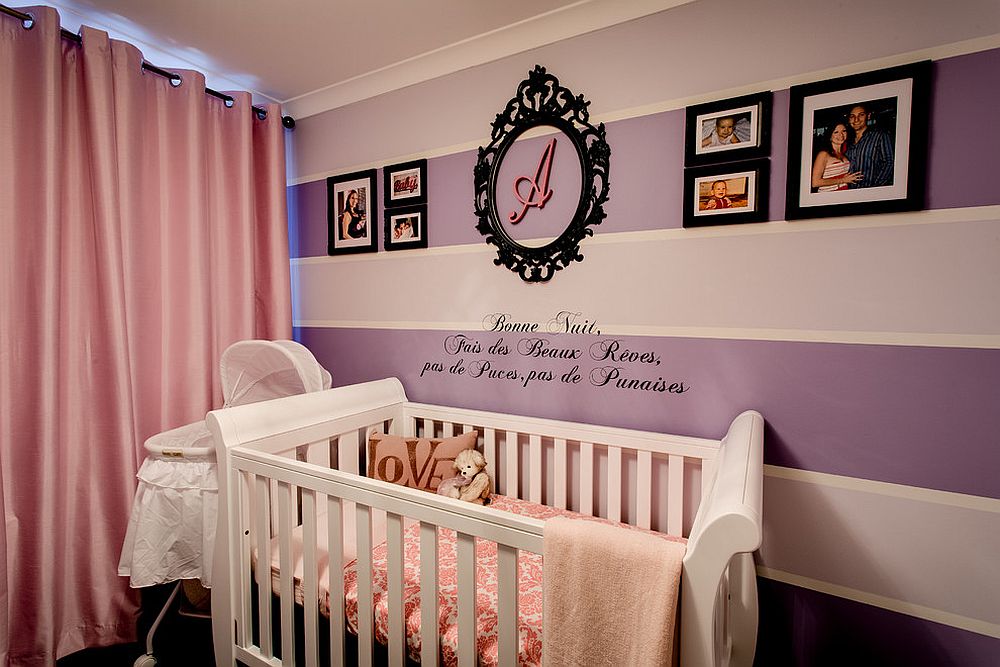 Purple and pink baby girl nursery with striped accent wall [Design: Interior Rejuvenations]