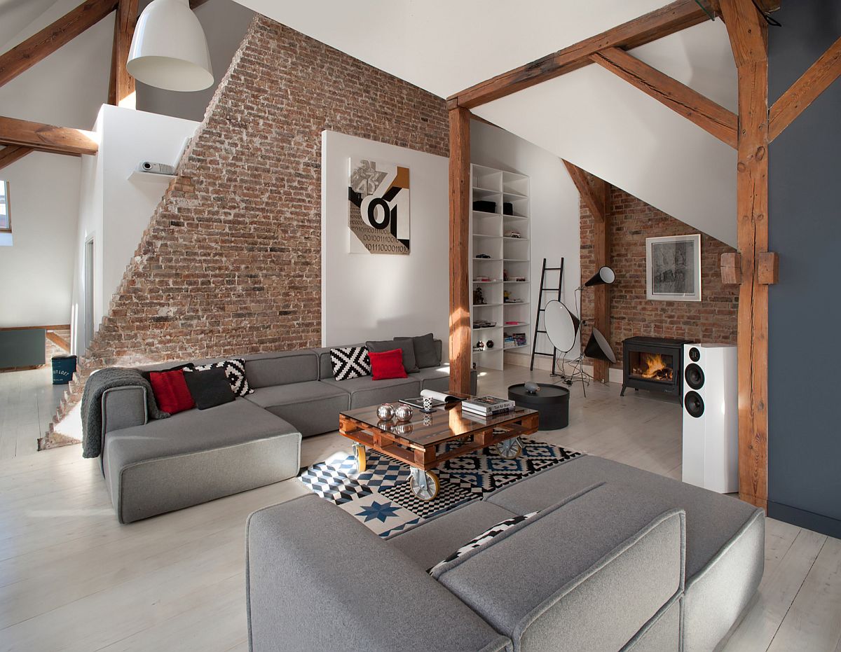 Restored original roof timber structure and brick walls of the Poznan apartment