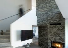 Sculptural-staircase-and-brick-fireplace-inside-the-contemporary-residence-in-Denmark-217x155