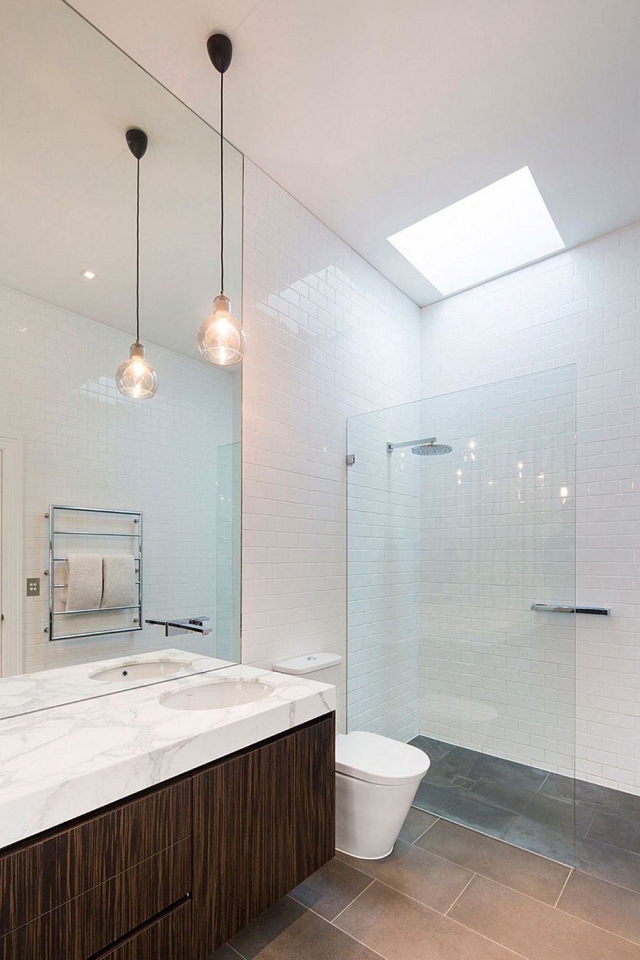 Skylight brings natural light into white, contemporary bathroom