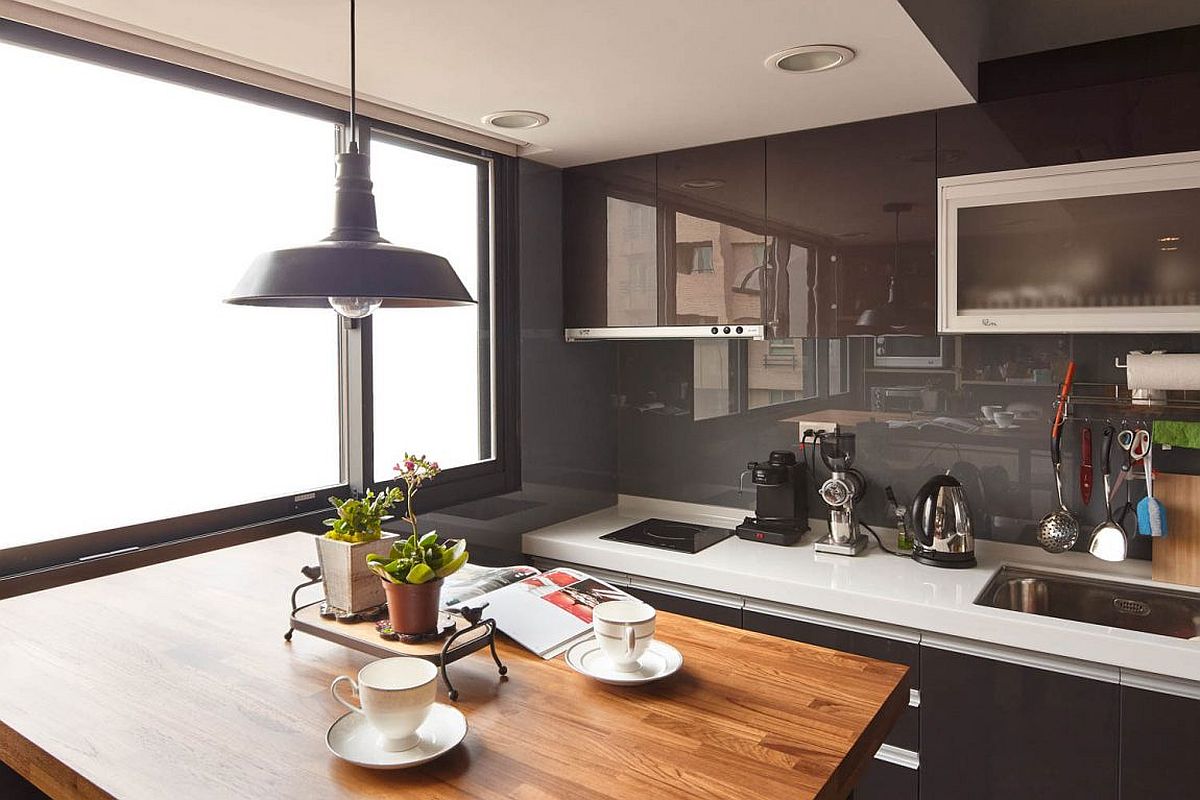 Small kitchen in the corner of industrial modern Taipei City apartment with a tiny dining station