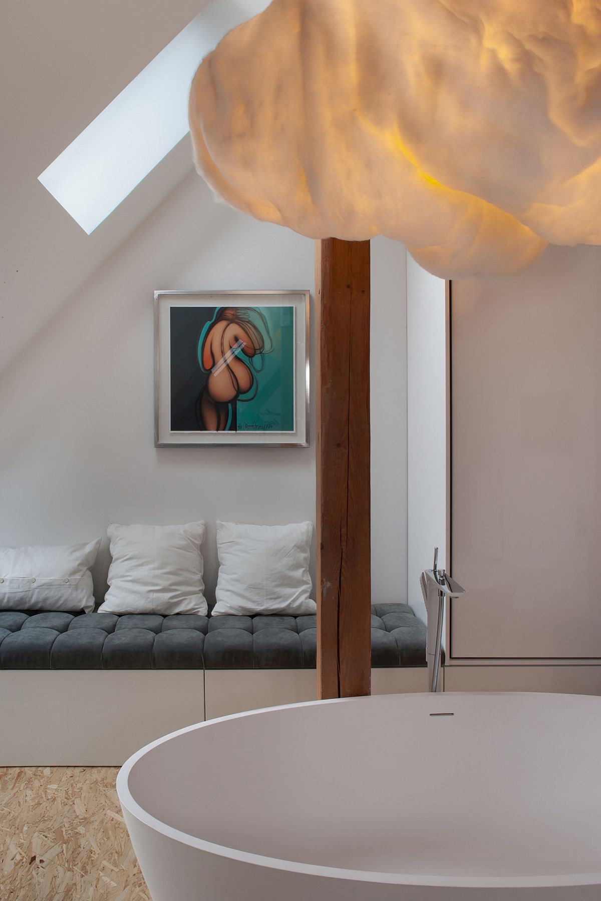 Soothing bathroom next to the bedroom with bathtub and cloud shaped lighting