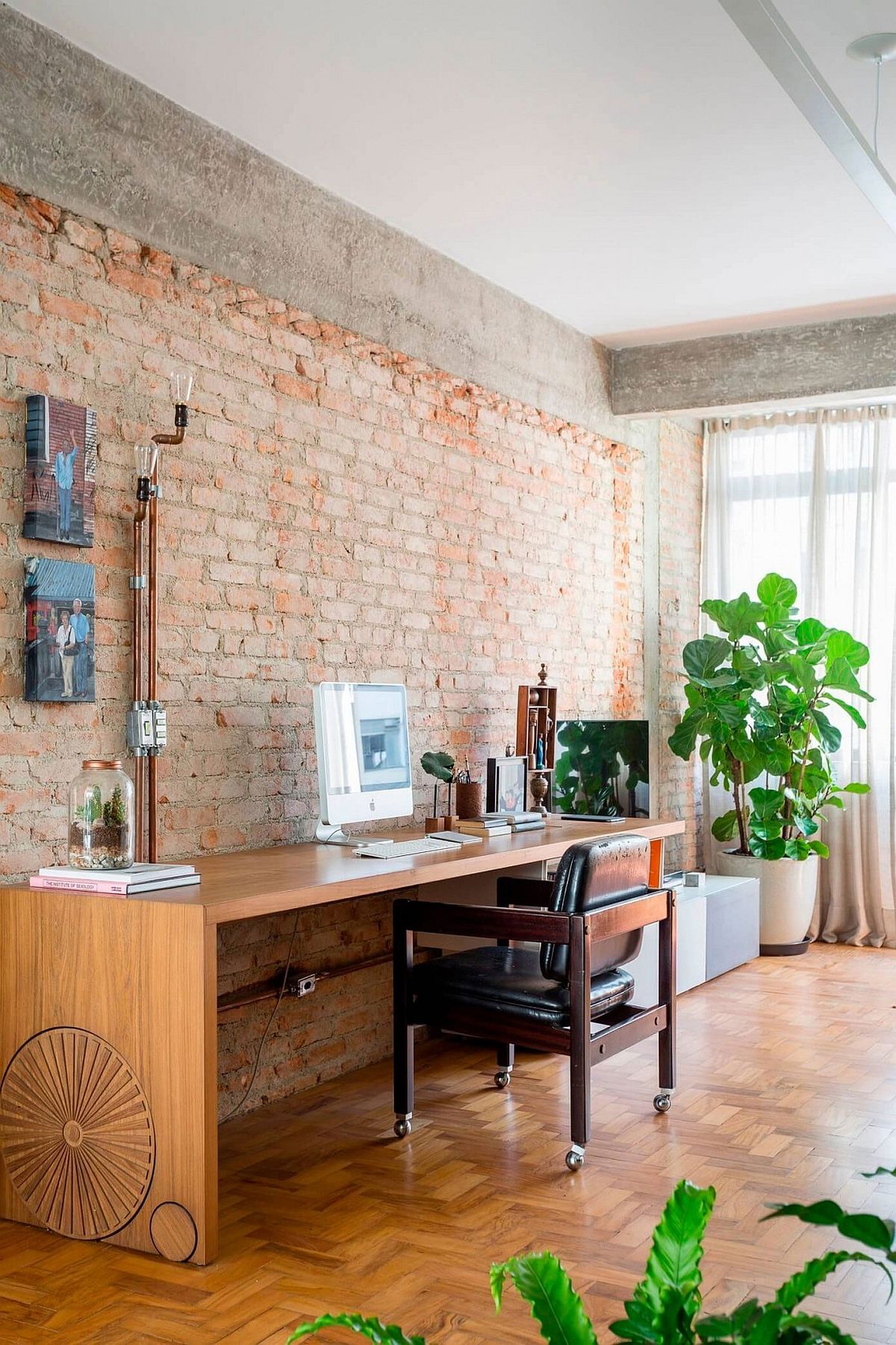 Spacious home workspace with brick walls