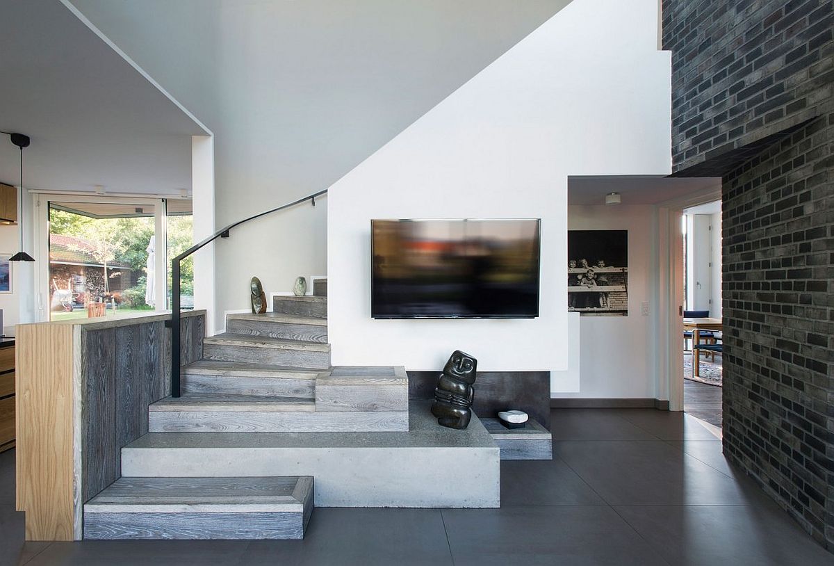 Staircase clad in wood leading to the top level