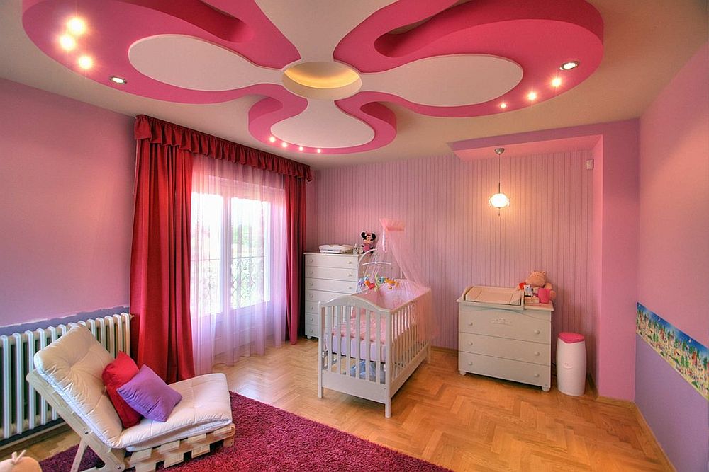 Stunning nursery in pink and purple with a ceiling design that is a showstopper