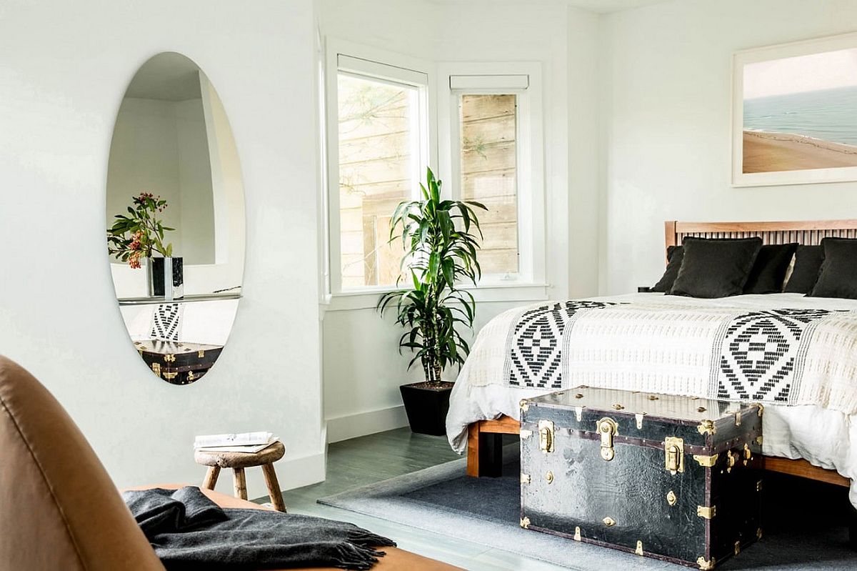 Vintage trunk turned into a table at the end of the bed