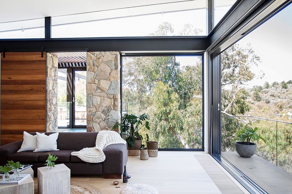 Window and sliding doors open up the corner to the view outside