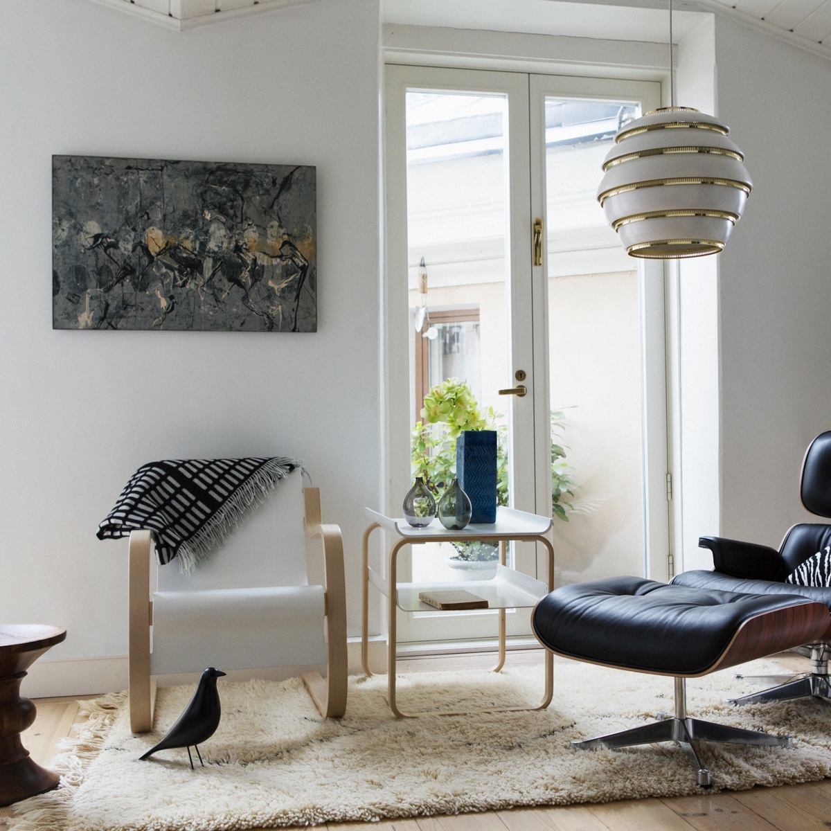 Alvar Aalto's designs shown alongside Vitra design pieces (Vitra acquired Artek in 2013). Aalto designs from left to right: Armchair 42 (1932), Table 915 (1932) and Pendant Light A331 (1953).