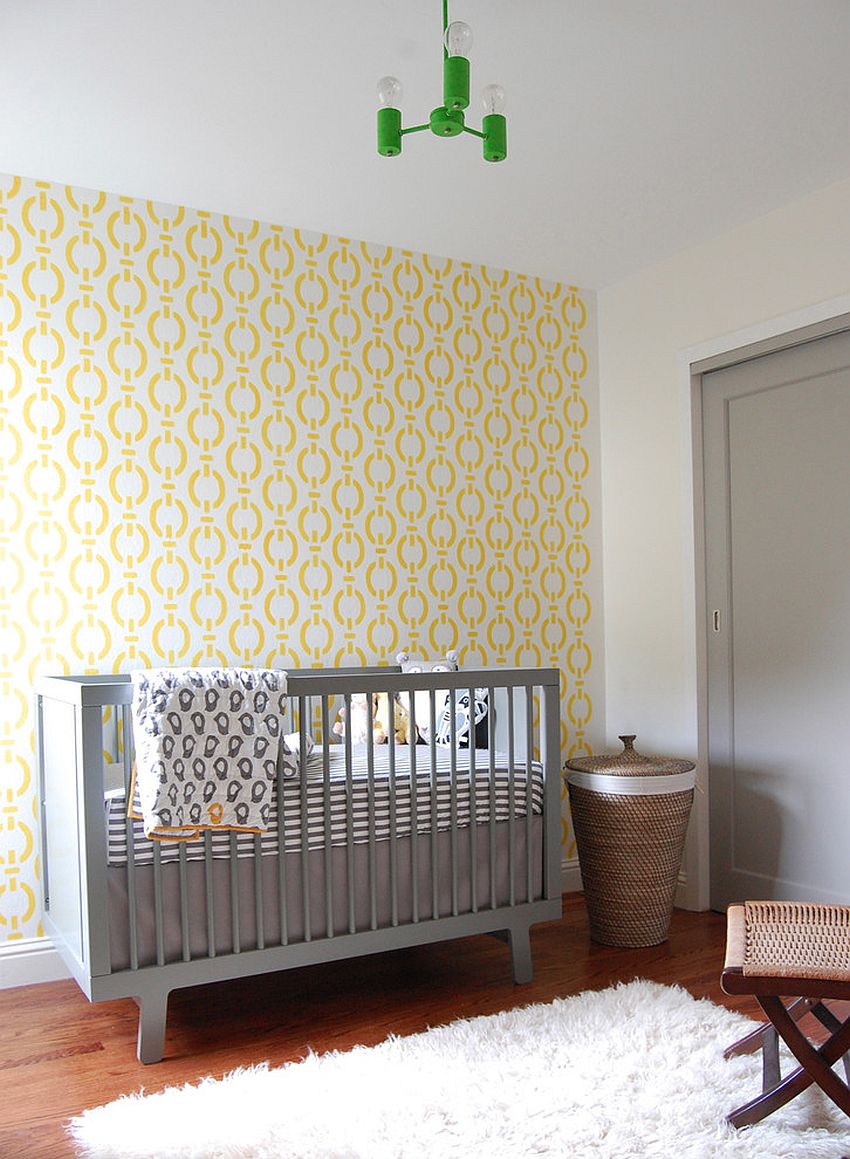 Beautiful wallpaper brings yellow while the crib adds gray to the modern nursery