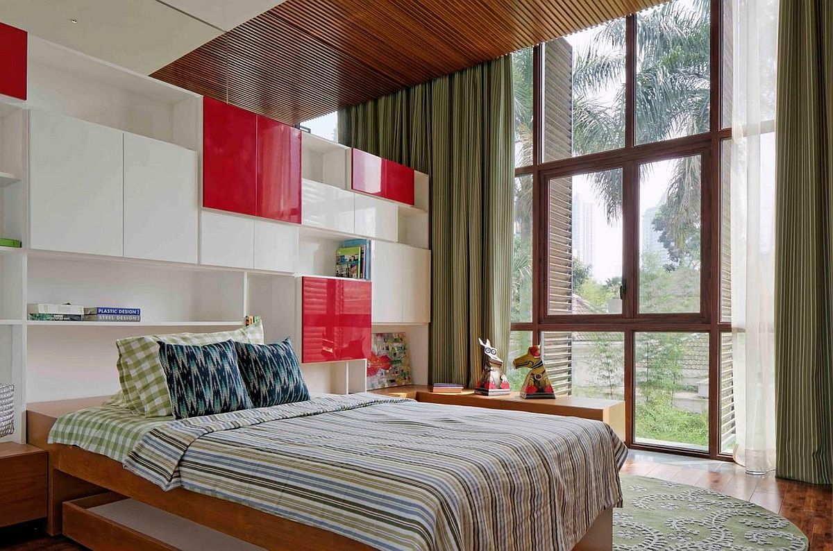 Bedroom with wooden shutters and colorful pops of red