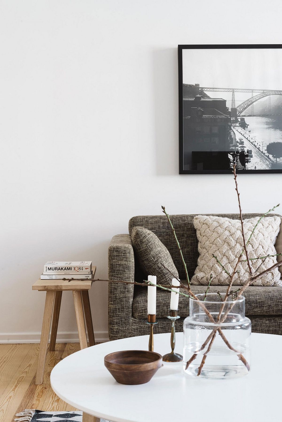 Black and white framed wall art plays into the neutral color scheme of the living room