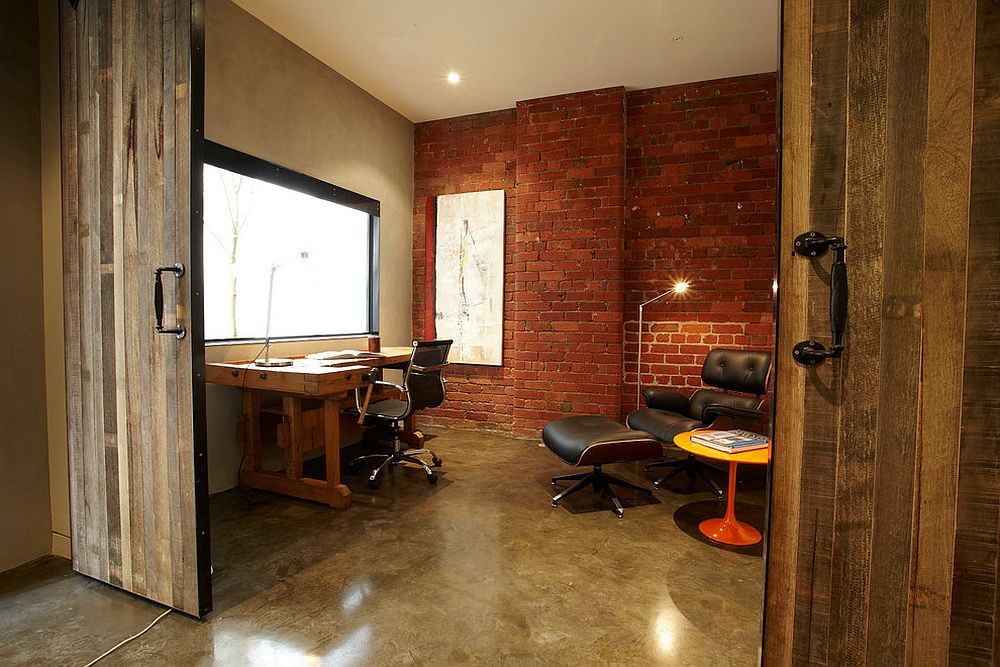 Brick wall and sliding barn door for the home office in revamped warehouse residence