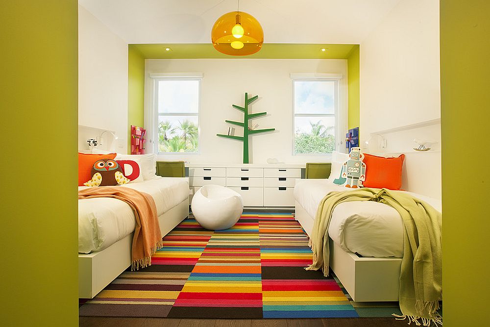 Bright and cheerful kids' room with twin beds seems super fun thanks to the multi-colored rug [Design: DKOR Interiors Inc.- Interior Designers Miami]