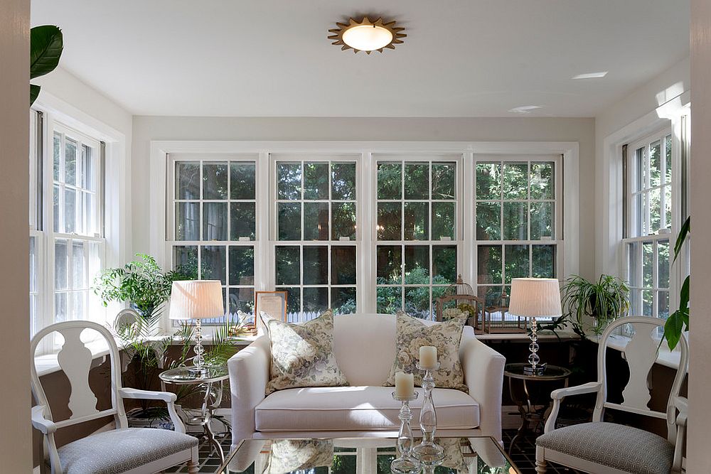 Chairs and table lamps add symmetry to the sunroom [Design: M&P Design Group]