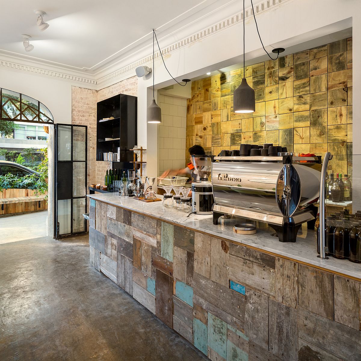 Concrete floors and reclaimed surfaces preserve the original charm of the restaurant