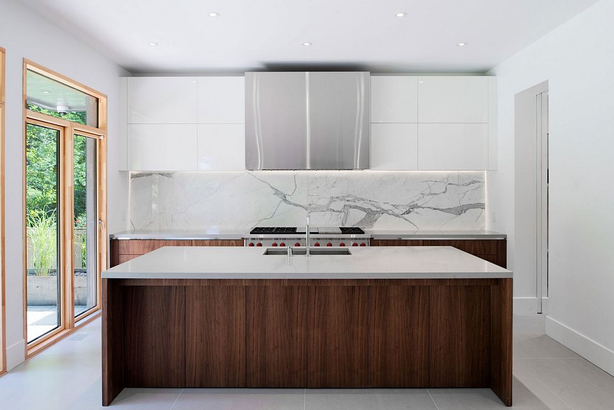 Contemporary kitchen in white with wooden lower cabinets, island and a marble backsplash