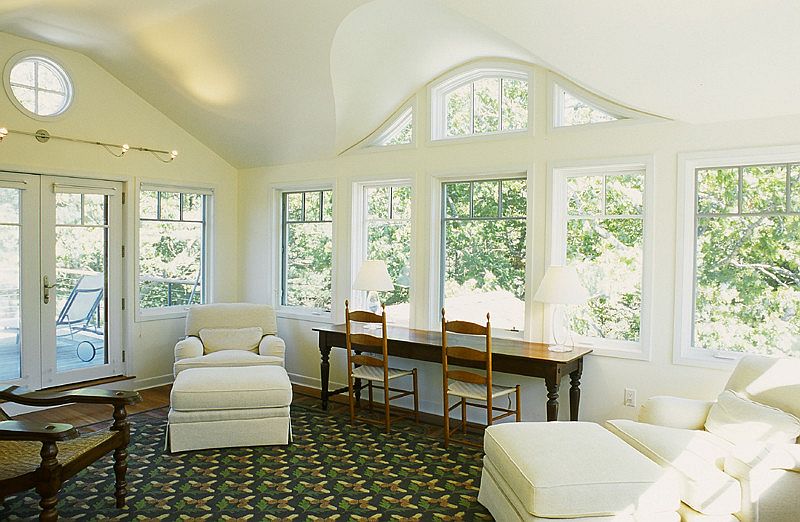 Cozy seating and a workdesk add to the appeal of the sunroom