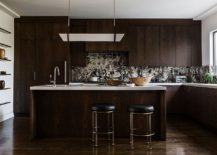Dark-wooden-cabinets-and-a-unique-backsplash-create-a-stunning-modern-kitchen-217x155