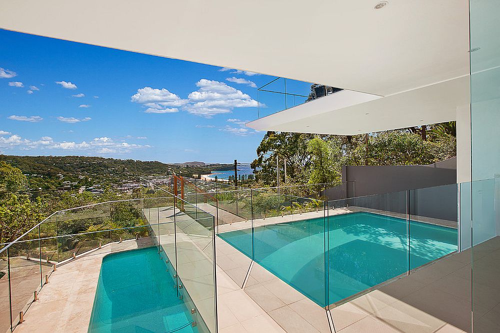 Dramatic entryway with a bridge above the pool