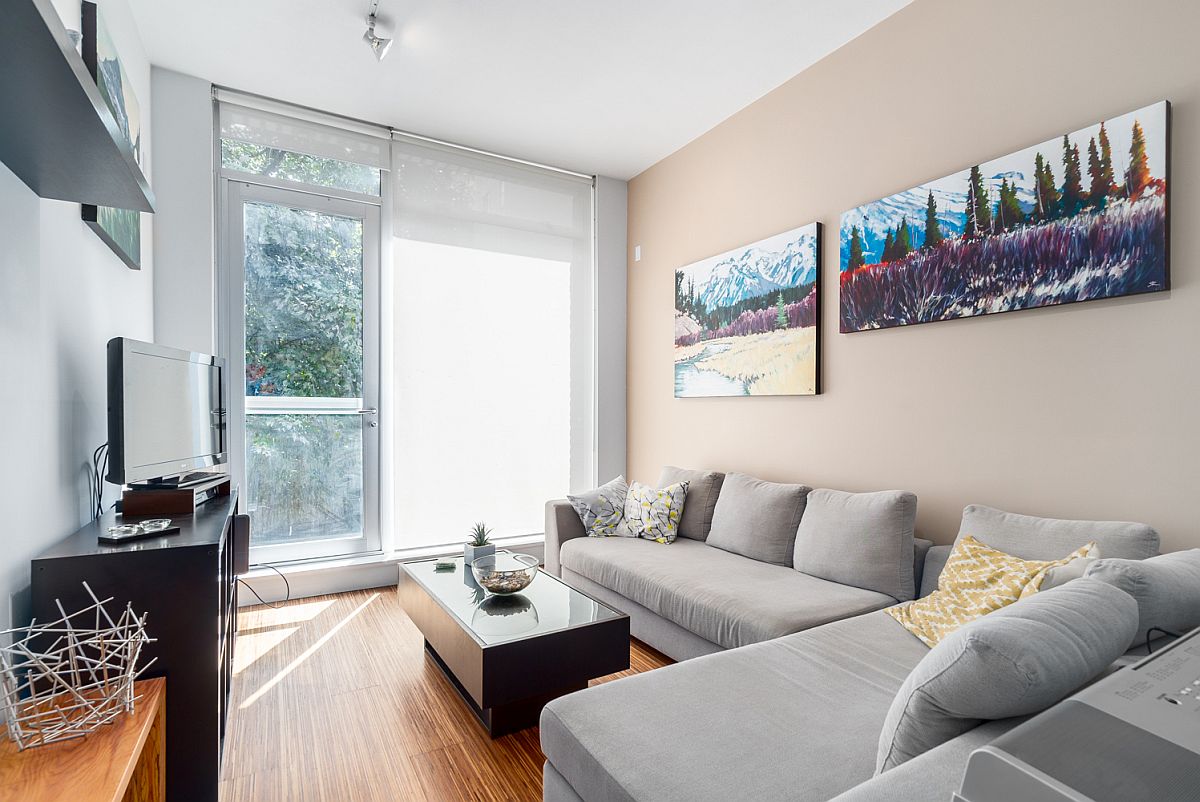 Elegant little living room of the Water Street apartment flooded with natural light