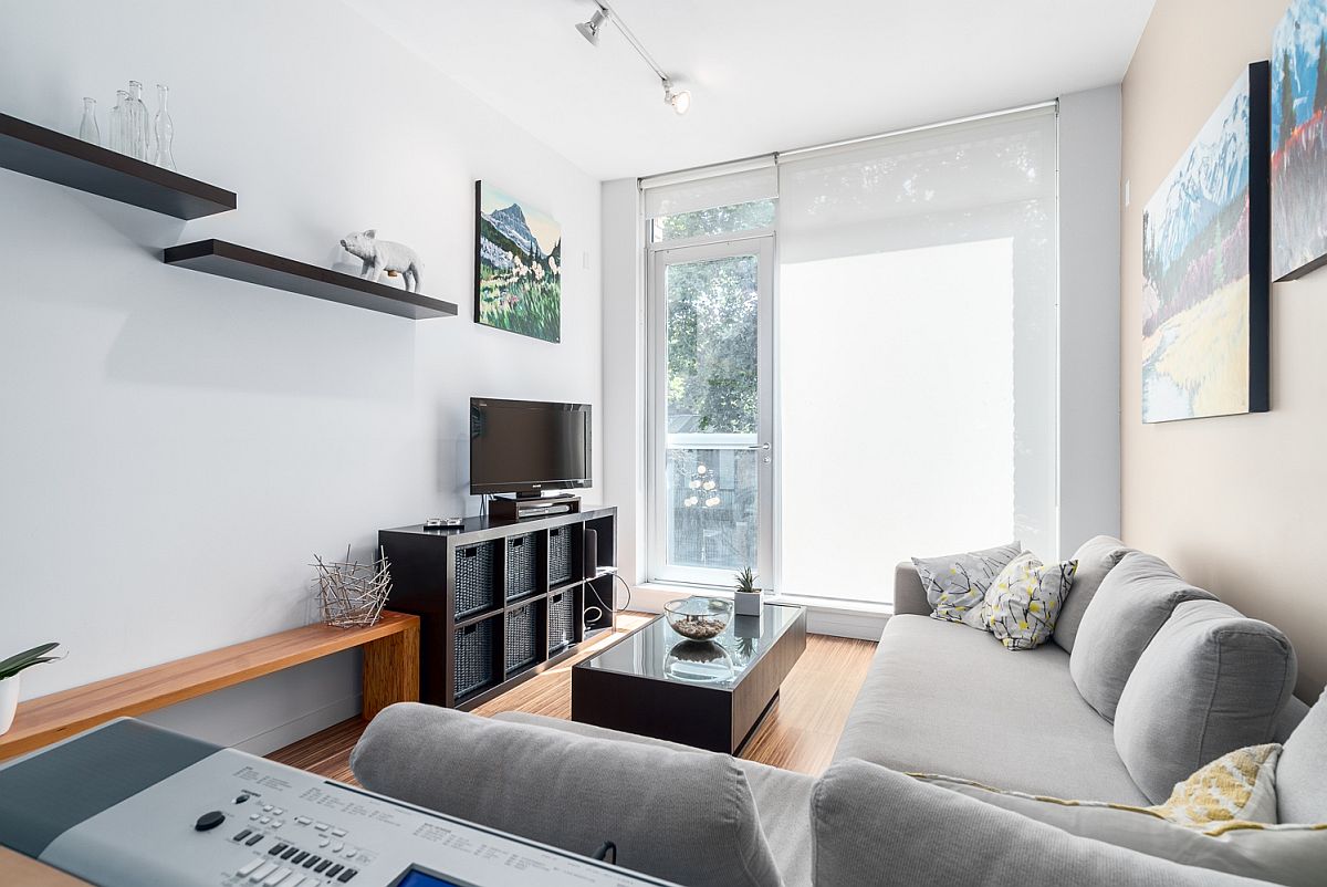 Floating shelves and wooden bench in the living room give it an airy appeal