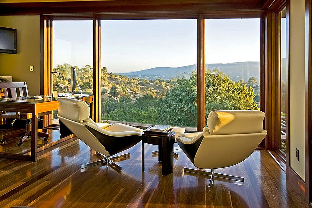 Floor-to-ceiling windows open up the home office to the lovely view outside