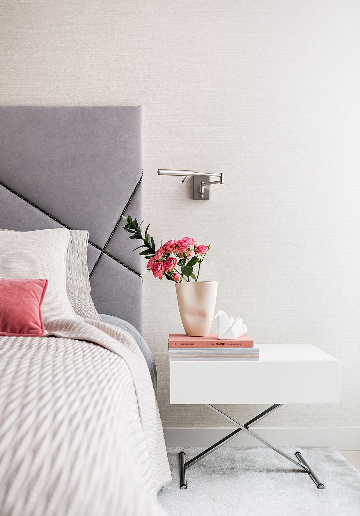 Flower on the nightstand bring a feminine touch to the luxurious bedroom