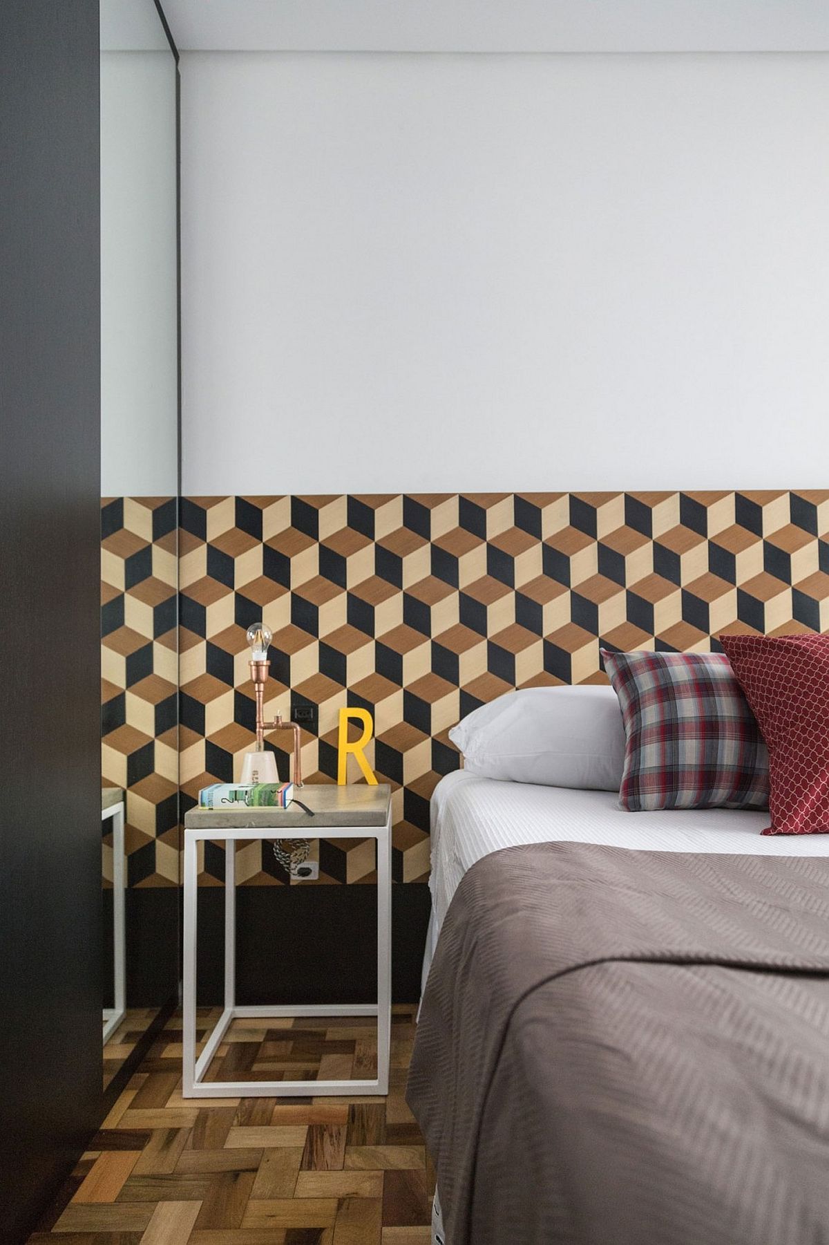 Geometric wallpaper with 3D design spices up the bedroom