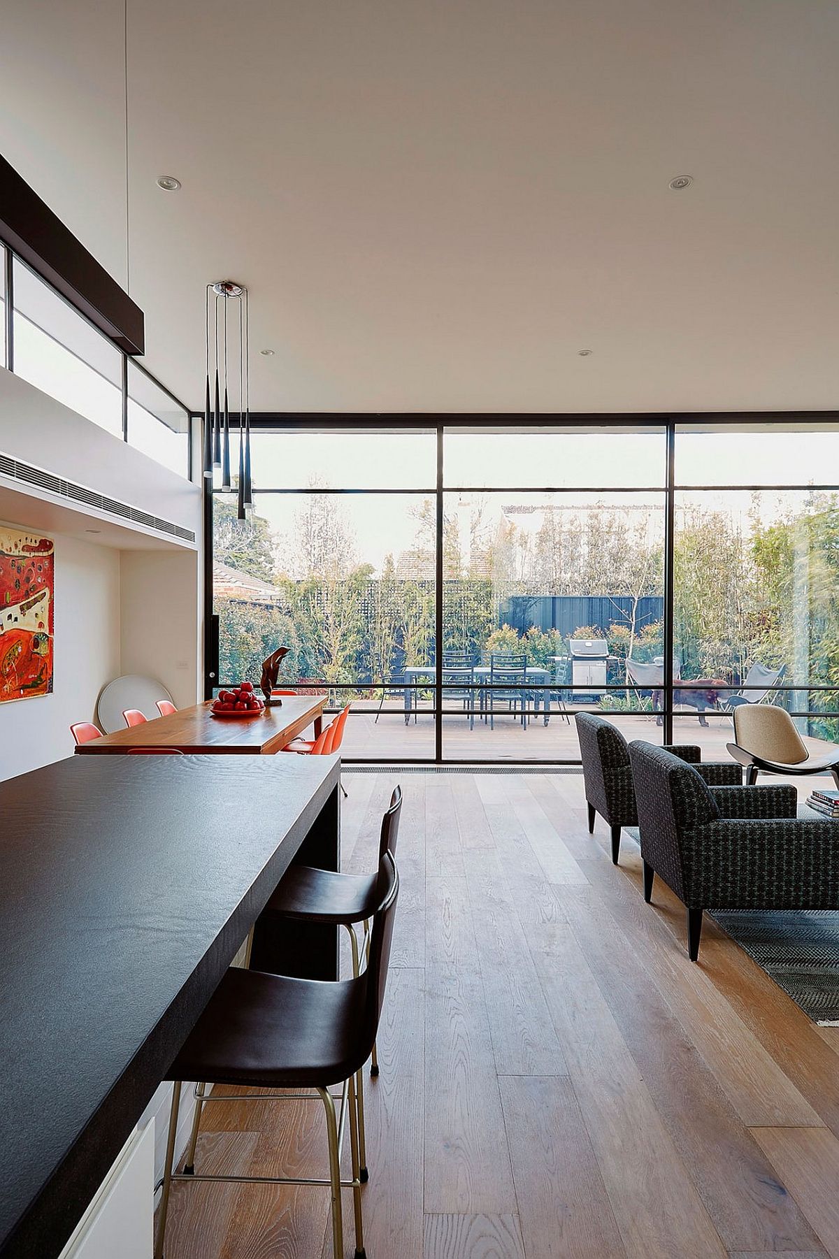 Glass walls provide protection from the elements while keeping the interior connected with the backyard