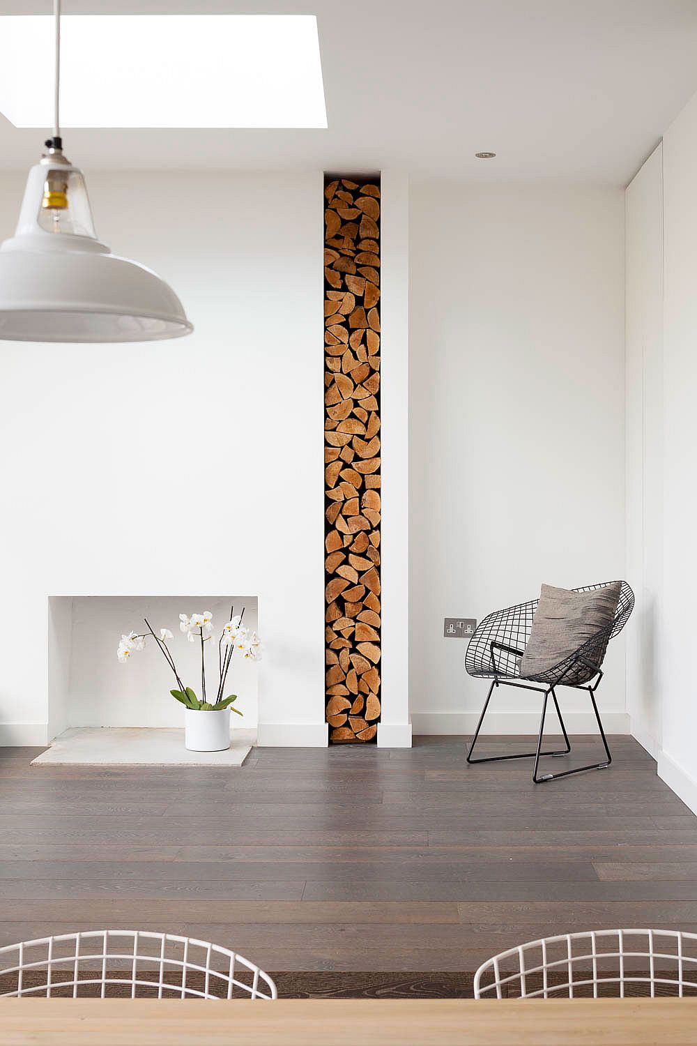 Gorgeously stacked firewood adds a new texture to the contemporary interior