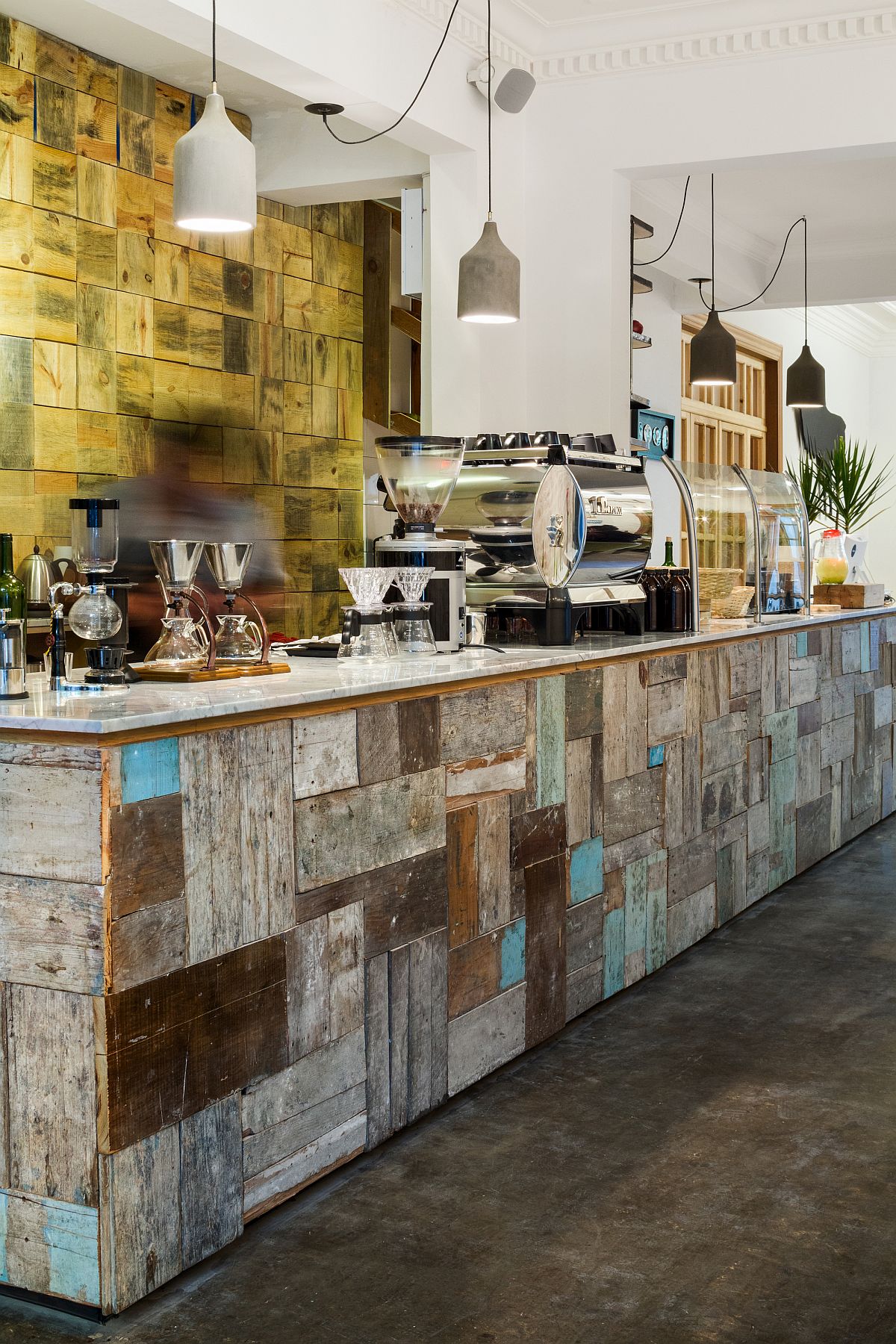 Interior of the coffee house uses reclaimed materials and colorful tiles