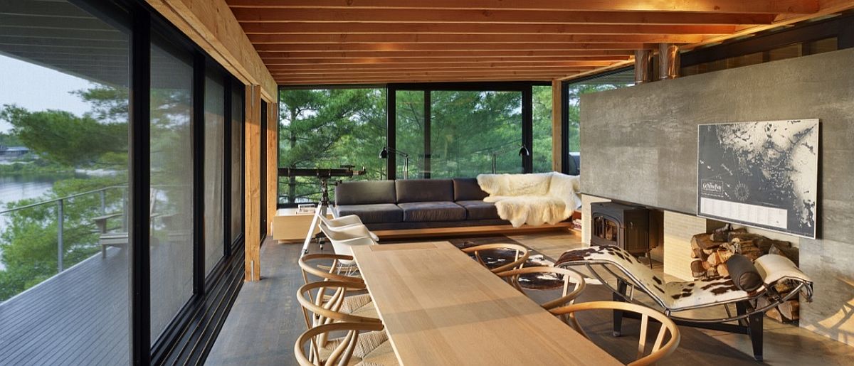 LIving area and dining space of teh idyllic cabin connected with the deck outside