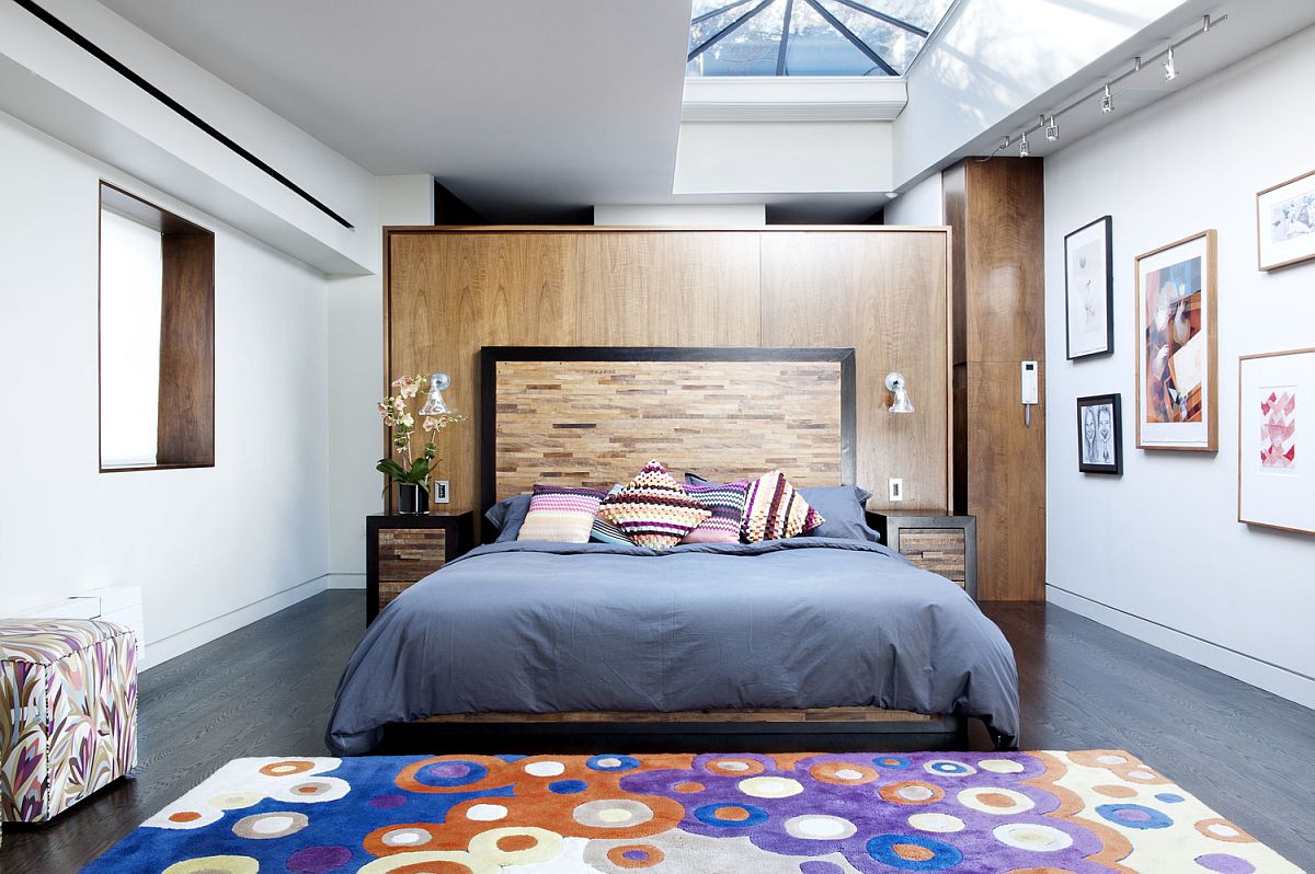 Luxurious bedroom of the New York penthouse with colorful rug and skylights