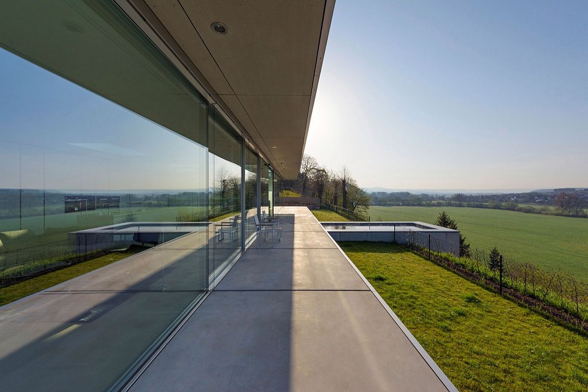 Minimalist villa overlooks stunning forest landscape and natural greenery