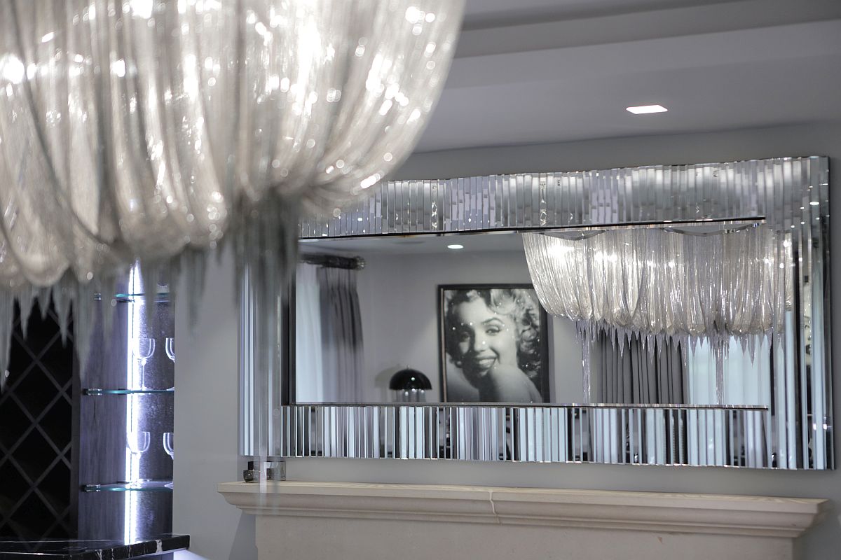 Mirrored finishes and silvery decor enhance the art deco aura of the home