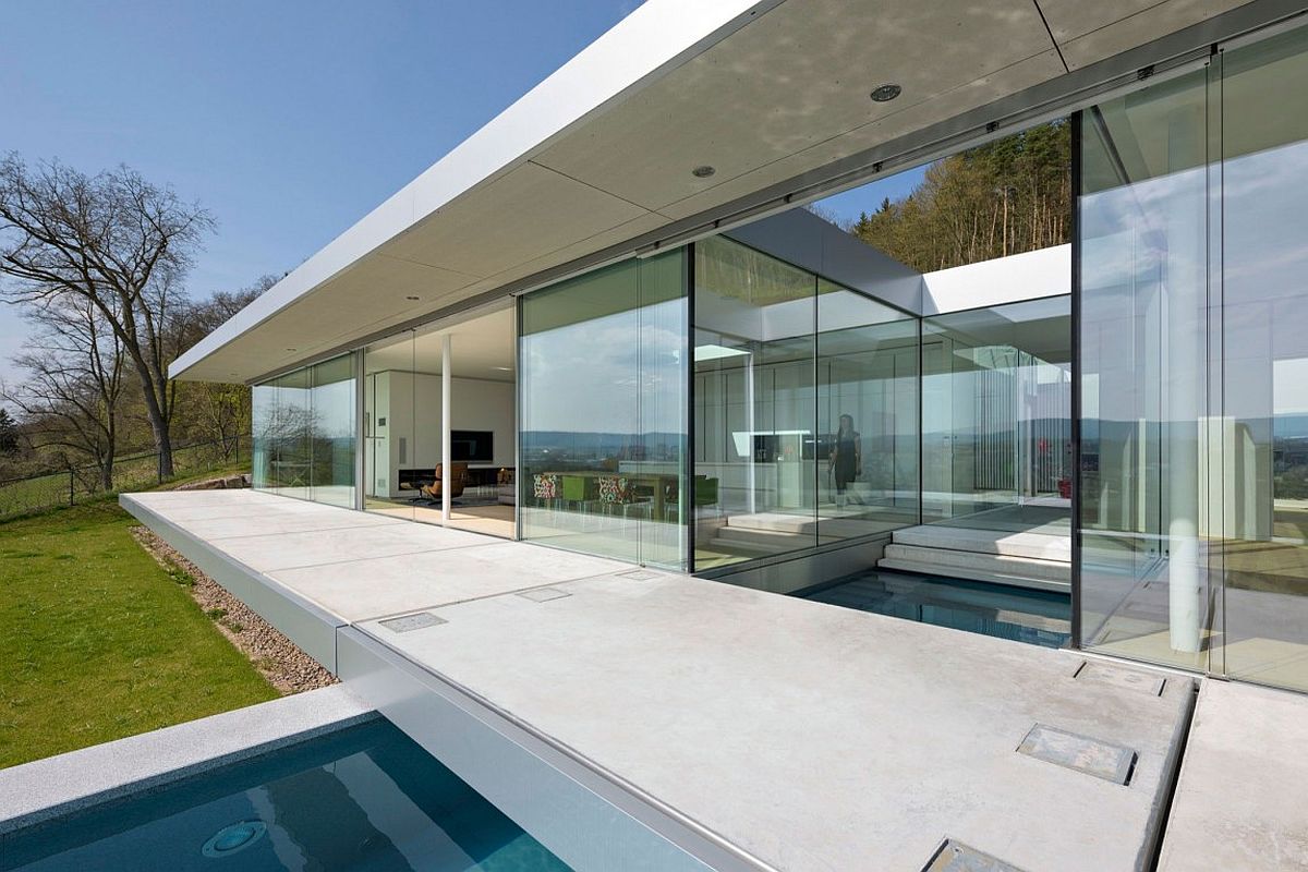 Modern minimal villa in Germany where the pool intersects with the house