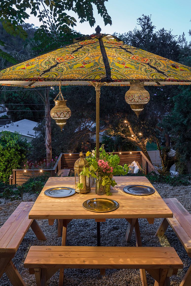 Moroccan lanterns and patterned umbrella complete an eclectic outdoor dining space [Design: Shannon Ggem / Photography: michael Kelley]